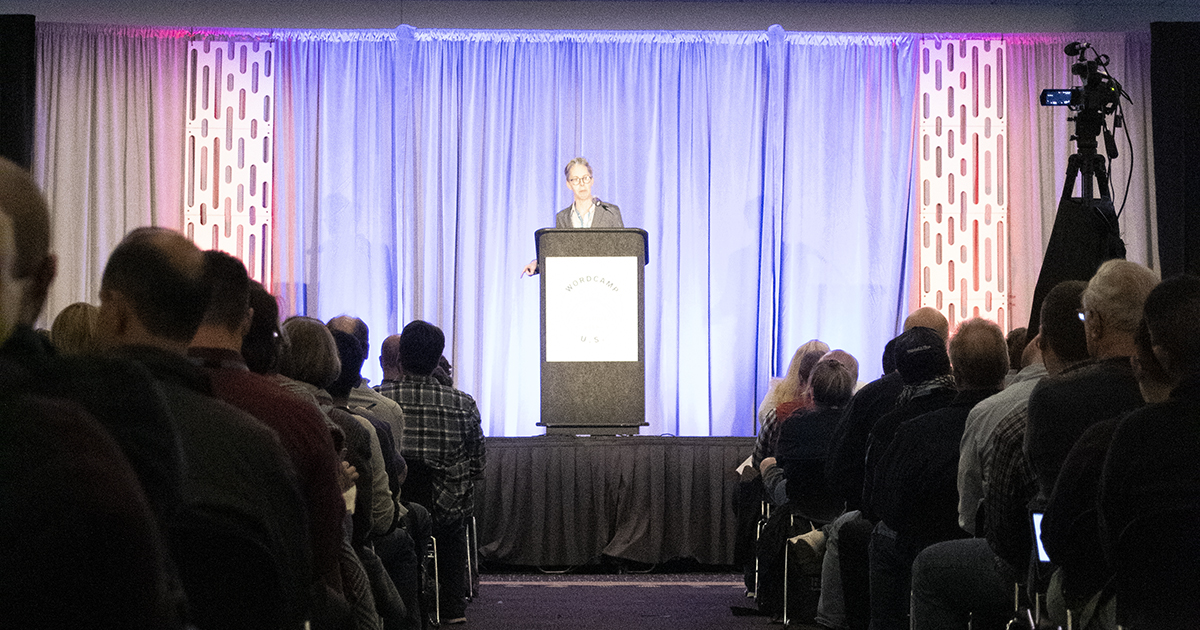 Chris Ford speaking behind a podium at WCUS 2019