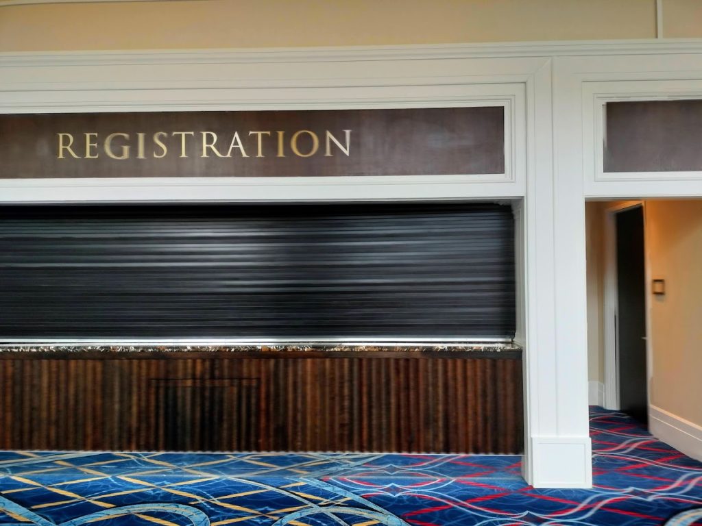 A convention center's registration desk with a closed window.