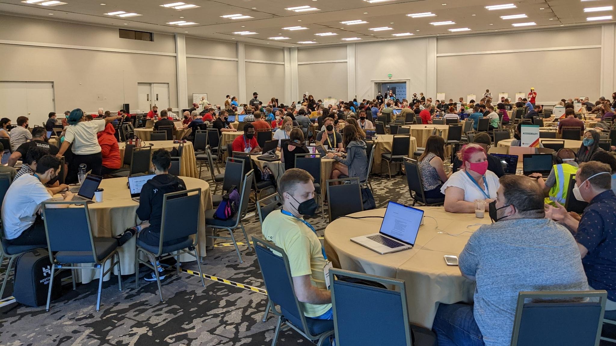 A wide view of Contributor Day within a convention hall at a previous WordCamp US