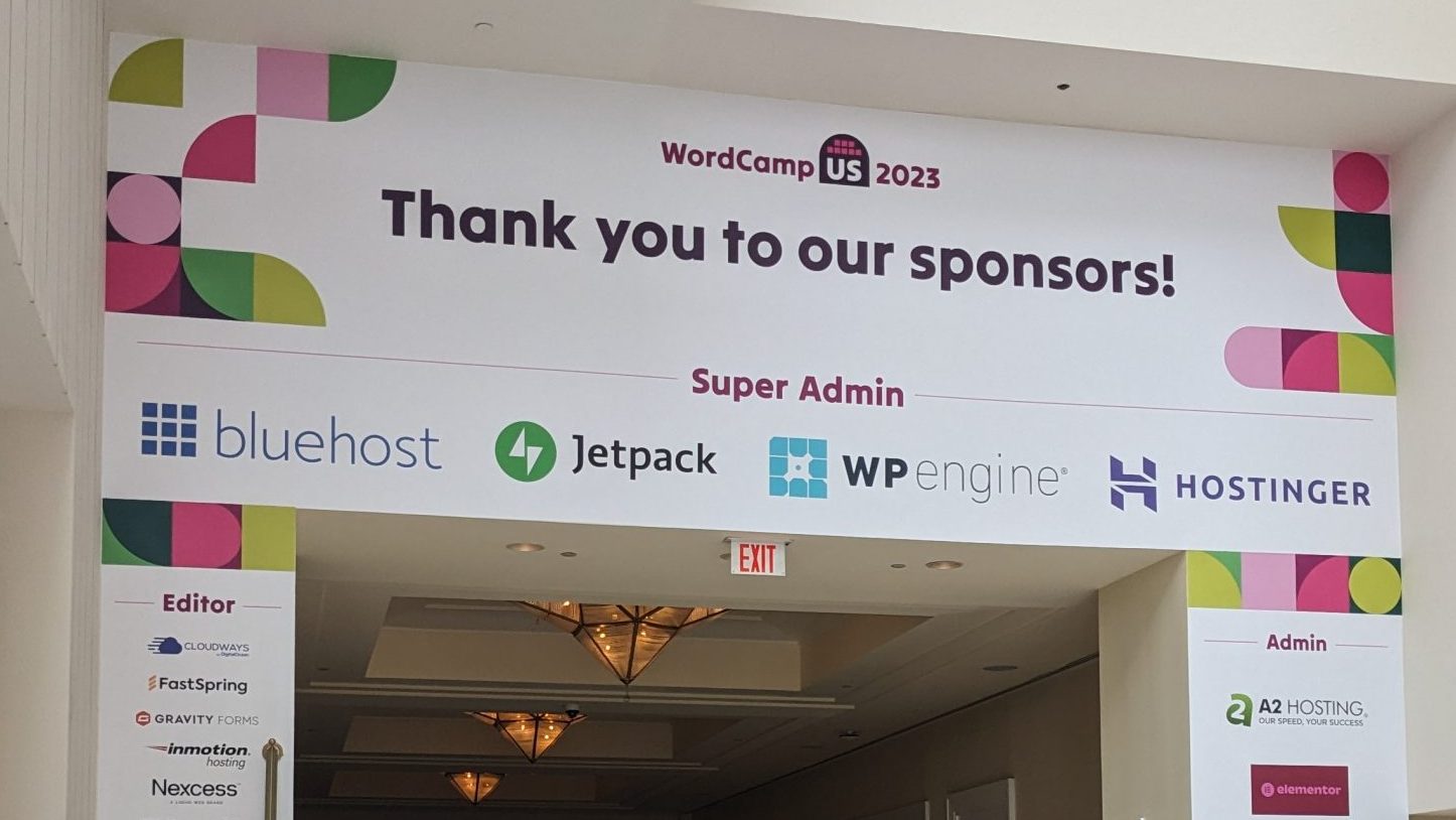 An arch at a WordCamp containing a thank you to sponsors, including their logos