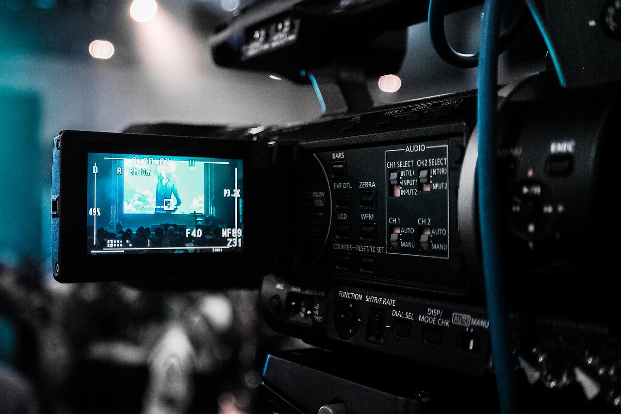 A video camera pointed at a conference speaker